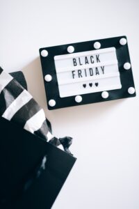 A Black and White Sign that says Black Friday and a shopping bag