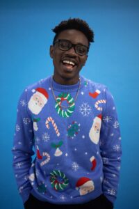 A Man in Blue Ugly Christmas Sweater Singing
