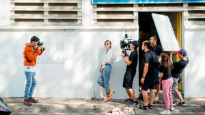 You'll need HR Tools to run a production and media company that works on-location on film sets like this one. From the cinematographer, to the actors and lighting specialists shown on an outdoor street - they all will need HR support. 