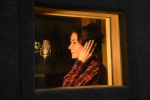 Elizabeth Saydah in her booth Recording and Laughing